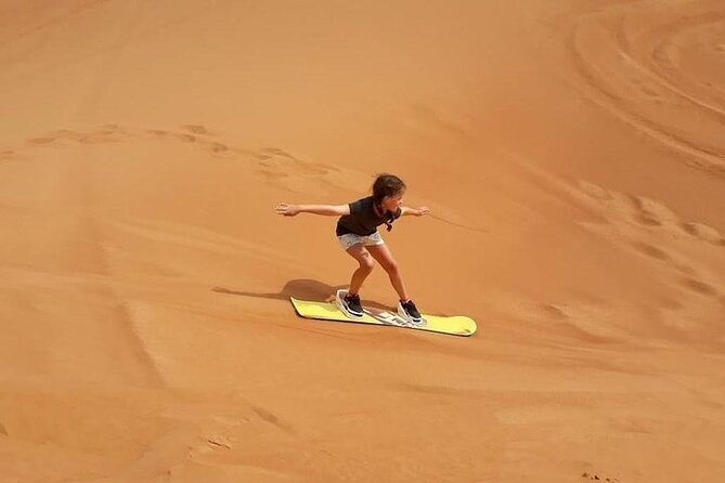 Dubai Self-drive Quad Bike, Sand Boarding, Camels & Refreshments - Sandboarding Over Dubai’s Red Dunes (What It Actually Feels Like)